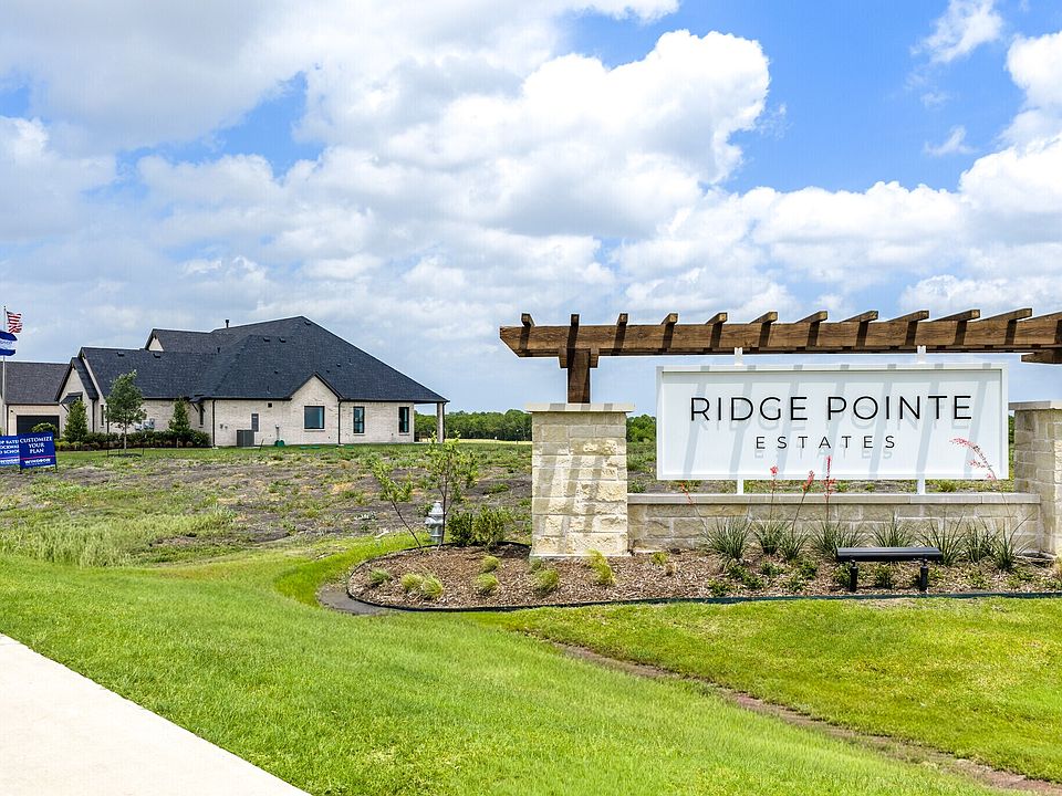 Ridge Pointe Estates entrance sign with pergola and a new home in McLendon-Chisholm, Texas